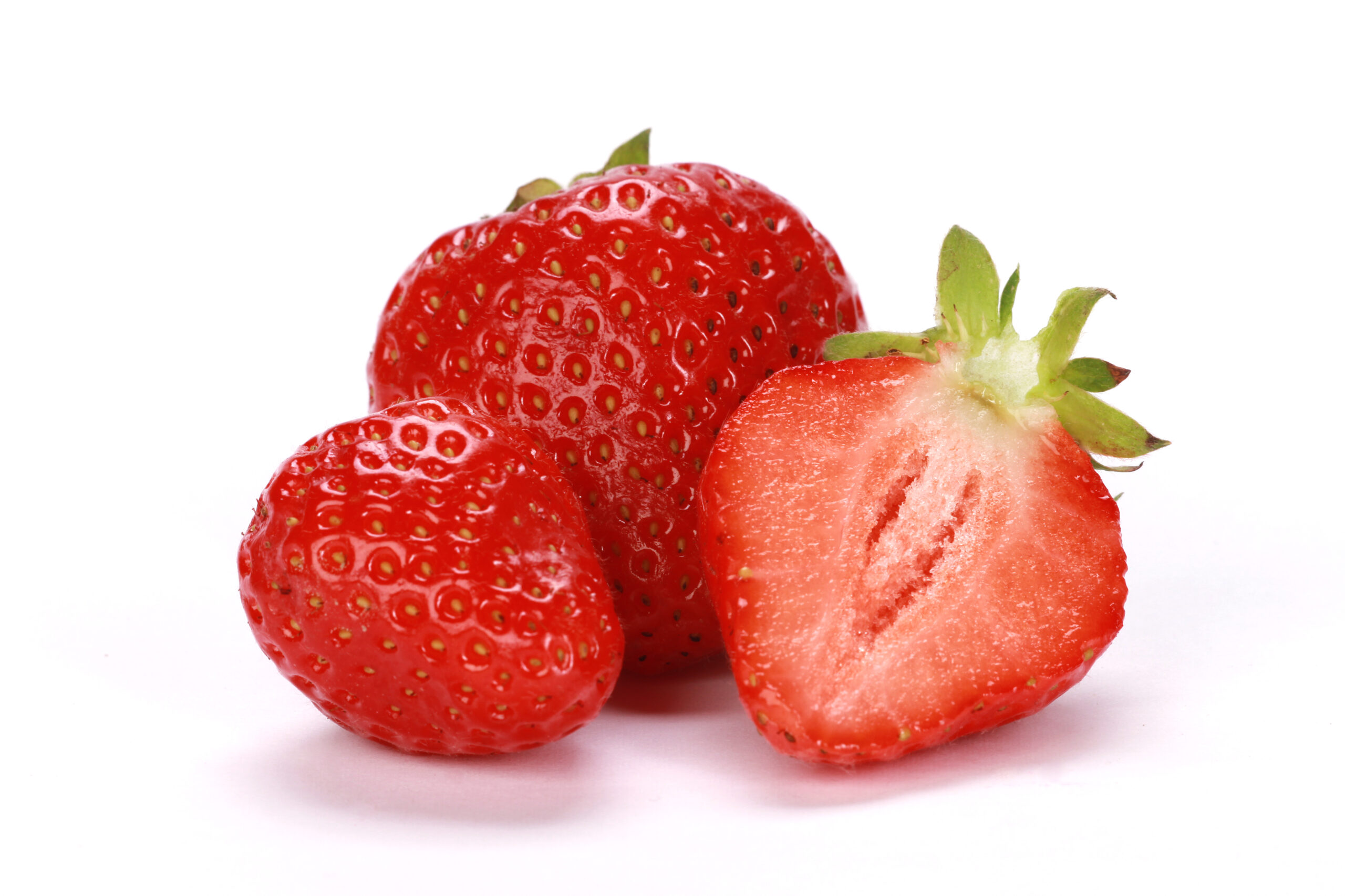 Closeup shot of fresh ripe strawberries isolated on a white background